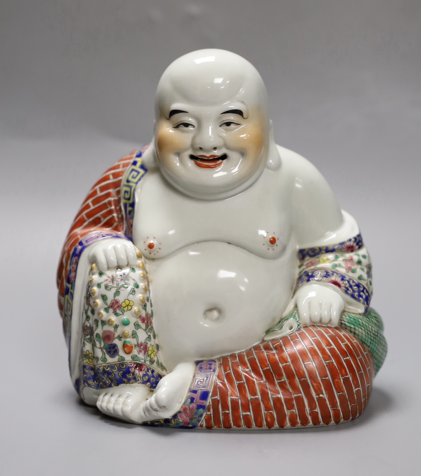 A Chinese enamelled porcelain seated Buddha, 19cm